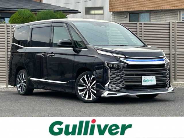 トヨタ ヴォクシー ハイブリッド S－Z 千葉県 2024(令6)年 2.2万km スパークリングブラックパールクリスタルシャイン 純正10.5インチディスプレイオーディオナビ/フルセグTV/HDMI/Bluetooth/ETC2.0/モデリスタエアロパーツセット/モデリスタシグニチャーイルミグリル/モデリスタイルミルーフスポイラー/パノラミックビューモニター/両側パワースライドドア/パワーバックドア/純正フリップダウンモニター/ヘッドアップディスプレイ/前後ドライブレコーダー/前後コーナーセンサー/1列目・2列目シートヒーター/2列目オットマン/ハーフレザーシート/デジタルインナーミラー/ブラインドスポットモニター/プリクラッシュセーフティ/レーンディパーチャーアラート/ロードサインアシスト/緊急時操舵支援/フロントクロストラフィックアラート/レーンチェンジアシスト/安心降車アシスト/オートハイビーム/ウィンカーミラー/プッシュスタート/スマートキー/スペアキー1本/ドアバイザー/リアサンシェード/ステアリングスイッチ/LEDヘッドライト/モデリスタ18インチアルミホイール/純正フロアマット/保証書/取扱説明書