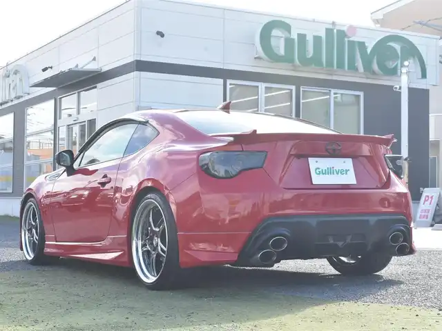 トヨタ ８６ GT リミテッド 神奈川県 2012(平24)年 5.7万km ライトニングレッド USトヨタ直輸入純正エンブレム/モデリスタエアロ（F・S・R）/TOM’S4本出しマフラー/：TOM’S4スモークテールレンズ/車高調/社外ディスプレイオーディオ/Bluetooth/バックカメラ/FM/AM/パイオニアパワードサブウーファー（）/プッシュスタート/ドライブレコーダー（前後）/社外シルバーメッキ19インチアルミホイール/：235/35R19/ハーフレザーシート/：シートヒーター前席/フロアマット