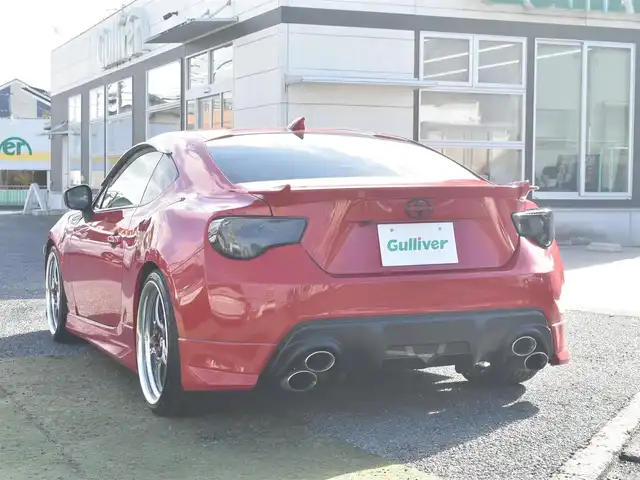 トヨタ ８６ GT リミテッド 神奈川県 2012(平24)年 5.7万km ライトニングレッド USトヨタ直輸入純正エンブレム/モデリスタエアロ（F・S・R）/TOM’S4本出しマフラー/：TOM’S4スモークテールレンズ/車高調/社外ディスプレイオーディオ/Bluetooth/バックカメラ/FM/AM/パイオニアパワードサブウーファー（）/プッシュスタート/ドライブレコーダー（前後）/社外シルバーメッキ19インチアルミホイール/：235/35R19/ハーフレザーシート/：シートヒーター前席/フロアマット