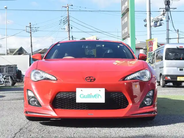 トヨタ ８６ GT リミテッド 神奈川県 2012(平24)年 5.7万km ライトニングレッド USトヨタ直輸入純正エンブレム/モデリスタエアロ（F・S・R）/TOM’S4本出しマフラー/：TOM’S4スモークテールレンズ/車高調/社外ディスプレイオーディオ/Bluetooth/バックカメラ/FM/AM/パイオニアパワードサブウーファー（）/プッシュスタート/ドライブレコーダー（前後）/社外シルバーメッキ19インチアルミホイール/：235/35R19/ハーフレザーシート/：シートヒーター前席/フロアマット