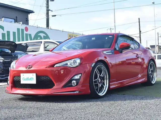 トヨタ ８６ GT リミテッド 神奈川県 2012(平24)年 5.7万km ライトニングレッド USトヨタ直輸入純正エンブレム/モデリスタエアロ（F・S・R）/TOM’S4本出しマフラー/：TOM’S4スモークテールレンズ/車高調/社外ディスプレイオーディオ/Bluetooth/バックカメラ/FM/AM/パイオニアパワードサブウーファー（）/プッシュスタート/ドライブレコーダー（前後）/社外シルバーメッキ19インチアルミホイール/：235/35R19/ハーフレザーシート/：シートヒーター前席/フロアマット