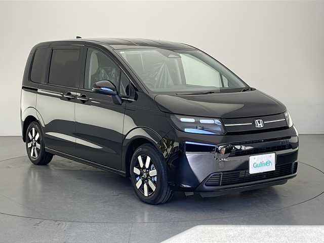 ホンダ フリード ハイブリット e:HEV AIR EX 長野県 2025(令7)年 0.1千km クリスタルブラックパール 登録済未使用車/純正9インチナビ/（フルセグ/Bluetooth/AppleCarPlay/AndroidAuto)/バックカメラ/ホンダセンシング/・衝突軽減ブレーキ/・レーンキープアシスト/・レーダークルーズコントロール/・ブラインドスポットモニター/・踏み間違い防止/・前後コーナーセンサー/両側電動スライドドア/電子パーキング/リア席サンシェード/LEDヘッドライト/オートライト/ウィンカーミラー/ハーフレザーシート/取扱説明書/保証書/スマートキー/スペアキー