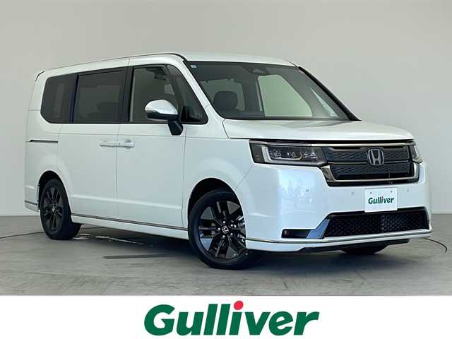 ホンダ ステップワゴン スパーダ eHEV 愛知県 2025(令7)年 0.1千km プラチナホワイトパール ・登録済未使用車/・純正11.4インチナビ/・Bluetooth/フルセグTV/CD/DVD/AppleCarPlay/・ハーフレザーシート/・D/Nシートヒーター/・パワーバックドア/・両側パワースライドドア/・2列目オットマン/・パドルシフト/・オートブレーキホールド/・オートLEDヘッドライト/・フォグライト/・スマートキー×２/・純正16インチアルミホイール/・サイド/カーテンエアバッグ/【ホンダセンシング】/・衝突軽減ブレーキ/・オートハイビーム/・誤発進抑制機能/・後方誤発進抑制機能/・路外逸脱警報機能/・アダプティブクルーズコントロール/・車線維持支援システム/・歩行者事故低減ステアリング^/・先行車発進お知らせ機能/・標識認識機能