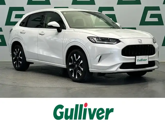 ホンダ ＺＲ－Ｖ Z 鹿児島県 2024(令6)年 2.1万km プラチナホワイトパール 禁煙車/純正9インチナビ(フルセグTV/Bluetooth)/全方位カメラ/ホンダセンシング/追従型クルーズコントロール/BOSEプレミアムサウンド/ブラインドスポットインフォメーション/後退出庫サポート/アダプティブドライビングビーム/運転席メモリー機能付きパワーシート/前席シートヒーター/前方ドライブレコーダー/ステアリングヒーター/本革シート/パワーバックドア/ワイヤレス充電/ETC/純正フロアマット/純正アルミホイール/LEDヘッドライト
