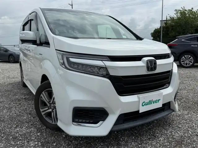 ホンダ ステップワゴン スパーダ ハイブリッド G EX ホンダセンシング 富山県 2018(平30)年 5.8万km プラチナホワイトパール 純正9型ナビ/　(Bluetooth/CD/DVD)/フルセグTV/両側パワースライドドア/バックモニター/ビルトインETC/純正ドライブレコーダー/渋滞追従機能付アダプティブクルコン/ホンダセンシング/・衝突軽減ブレーキ/・誤発進抑制機能/・車線維持支援システム/・標識認識機能/・先行車発進お知らせ機能/・歩行者事故低減ステアリング/LEDヘッドランプ/デュアルオートエアコン/本革巻きステアリング/ソフトウィーブ/合皮コンビシート/前席シートヒーター/2列目キャプテンシート/純正16インチアルミホイール/スマートキーシステム/禁煙車