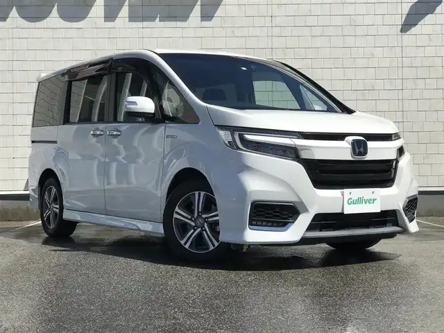 ホンダ ステップワゴン スパーダ ハイブリッド G EX ホンダセンシング 富山県 2018(平30)年 5.8万km プラチナホワイトパール 純正9型ナビ/　(Bluetooth/CD/DVD)/フルセグTV/両側パワースライドドア/バックモニター/ビルトインETC/純正ドライブレコーダー/渋滞追従機能付アダプティブクルコン/ホンダセンシング/・衝突軽減ブレーキ/・誤発進抑制機能/・車線維持支援システム/・標識認識機能/・先行車発進お知らせ機能/・歩行者事故低減ステアリング/LEDヘッドランプ/デュアルオートエアコン/本革巻きステアリング/ソフトウィーブ/合皮コンビシート/前席シートヒーター/2列目キャプテンシート/純正16インチアルミホイール/スマートキーシステム/禁煙車