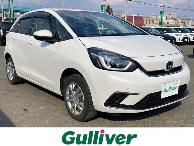ホンダ フィット e:HEVホーム 道東・釧路十勝 2021(令3)年 2.6万km プラチナホワイトパール 4WD/純正８インチSDナビ　/(フルセグTV/ＤＶＤ再生/Ｂｌｕｅｔｏｏｔｈ接続)　/ＥＴＣ　/バックカメラ　/渋滞追従機能付アダプティブ・クルーズ・コントロール/前後コーナーセンサー　/レーンアシスト　/衝突軽減ブレーキ/横滑り防止装置/アイドリングストップ　/スマートキー/プッシュスタート　/純正ＬＥＤヘッドライト/純正フロアマット