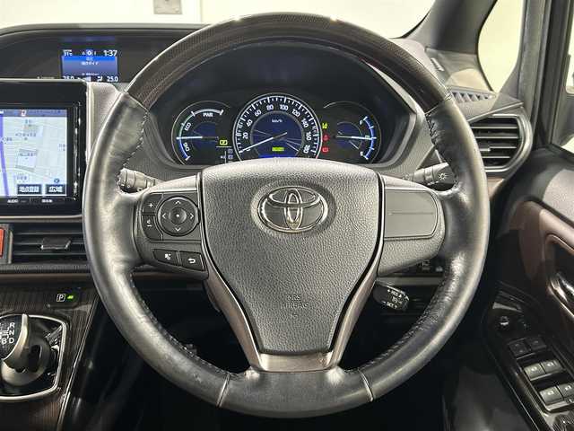トヨタ エスクァイア ハイブリッド Gi プレミアムパッケージ 愛知県 2018(平30)年 5.3万km スパークリングブラックパールクリスタルシャイン 純正９インチナビ/フリップダウンモニター/両側パワースライドドア/衝突軽減ブレーキ/レーンキープアシスト/先行車発進告知/クルーズコントロール/ハンドルヒーター/シートヒーター/ハーフレザー/ドライブレコーダー/ビルトインＥＴＣ２．０/AC100V1500W/アクセサリーソケット/純正15インチアルミホイール
