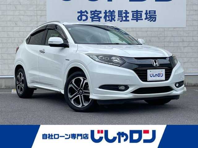 ホンダ ヴェゼル ハイブリッド Z 長崎県 2014(平26)年 9.4万km ホワイトオーキッドパール (株)IDOMが運営する【じしゃロン長崎店】の自社ローン専用車両になりますこちらは現金またはオートローンご利用時の価格です。自社ローンご希望の方は別途その旨お申付け下さい/ナビ　/バックカメラ　/ハーフレザーシート　/シートヒーター　/衝突被害軽減ブレーキ　/ＬＥＤヘッドライト　/オートライト　/フォグランプ　/クルーズコントロール　/パドルシフト　/ＥＴＣ　/プッシュスタート