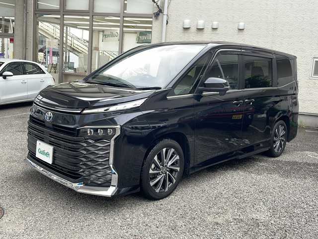 トヨタ ヴォクシー ハイブリッド S－Z 兵庫県 2022(令4)年 3.4万km グリッターブラックガラスフレーク ワンオーナー/純正ディスプレイオーディオ　フルセグ、CD、BT、AM、FM/　Miracast、HDMI/純正フリップダウンモニター/両側パワースライドドア/ドライブレコーダー前後/衝突被害軽減ブレーキ/コーナーセンサー/ハーフレザーシート/ビルトインETC２．０/シートヒーター/パワーバックドア/ブレーキホールド/レーンキープアシスト/クルーズコントロール（追従あり）/2列目オットマン/LEDヘッドライト/スマートキー×２/１００V充電