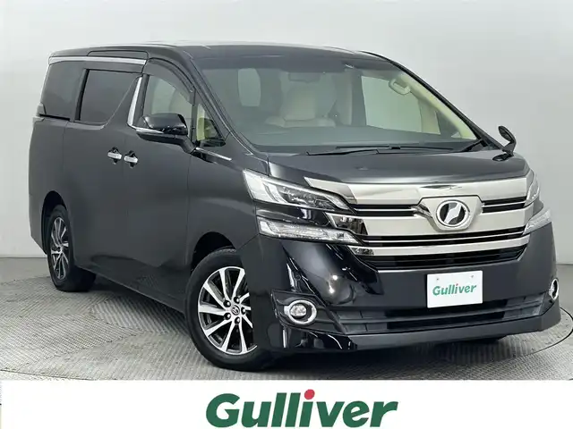 トヨタ ヴェルファイア V 道央・札幌 2015(平27)年 5.7万km ブラック ・純正9インチナビ/・フルセグTV/Bluetooth/CD/DVD/・ETC/・純正12.1インチフリップダウンモニター/・両側パワースライドドア/・クルーズコントロール/・アイドリングストップ/・クリアランスソナー/・電動サイドブレーキ/・ウッドコンビステアリング/・ステアリングリモコン/・ハーフレザーシート/・パワーシート(運転席/助手席)/・メモリシート(運転席)/・オットマン/・プッシュスタート/・スマートキー/・LEDヘッドライト/・オートライト/・フォグライト/・純正フロアマット/・ドアバイザー