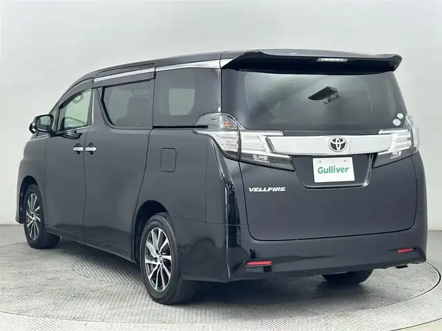 トヨタ ヴェルファイア V 道央・札幌 2015(平27)年 5.7万km ブラック ・純正9インチナビ/・フルセグTV/Bluetooth/CD/DVD/・ETC/・純正12.1インチフリップダウンモニター/・両側パワースライドドア/・クルーズコントロール/・アイドリングストップ/・クリアランスソナー/・電動サイドブレーキ/・ウッドコンビステアリング/・ステアリングリモコン/・ハーフレザーシート/・パワーシート(運転席/助手席)/・メモリシート(運転席)/・オットマン/・プッシュスタート/・スマートキー/・LEDヘッドライト/・オートライト/・フォグライト/・純正フロアマット/・ドアバイザー