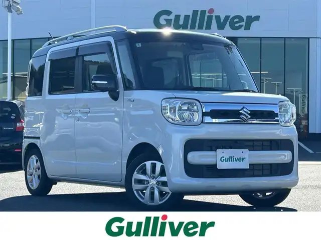 スズキ スペーシア HYBRID X 島根県 2018(平30)年 1.6万km ピュアホワイトパール/ブラック2トーン 登録時走行距離15117km/ワンオーナー/純正ナビ/Bluetooth・AM・FM・CD・DVD/フルセグテレビ(走行中視聴可能)/全周囲カメラ/バックカメラ/フロントカメラ/サイドカメラ/両側パワースライドドア/シートヒーター(運転席・助手席)/LEDヘッドライト/オートライト/ヘッドアップディスプレイ/ビルトインETC/純正フロアマット/純正14インチAW/後方コーナーセンサー/レーンキープアシスト/衝突被害軽減ブレーキ/横滑り防止装置/後席サンシェード/ドアバイザー/ウィンカーミラー/スマートキー(スペアキー×1)/シートカバー付き/スタッドレスタイヤ付き/禁煙車