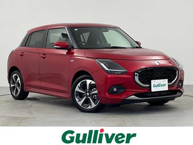 スズキ スイフト HYBRID MZ 愛知県 2024(令6)年 0.6万km バーニングレッドPM /スズキ純正9インチディスプレイオーディオ//AM/FM/BT/USB/iPod/AppleCarPlay/Android Auto//スズキセーフティサポート//デュアルセンサーブレーキサポート//レーンディパーチャーアラート//ブラインドスポットモニター//オートハイビーム//ハイビームアシスト//オートクルーズコントロール//レーンサインアシスト//レーンキープアシスト//ふらつき警告機能//発進お知らせ機能//誤発進抑制機能//ブレーキオートホールド//シートヒーター（D/N席）//電動格納ウィンカーミラー//ステアリングスイッチ//パドルシフト//革巻きステアリング//16インチ純正アルミホイール//LEDオートヘッドライト//LEDフォグランプ//純正フロアマット//トノカバー