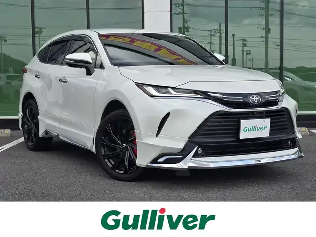 トヨタ ハリアー Z レザーパッケージ 福岡県 2021(令3)年 3.8万km ホワイトパールクリスタルシャイン ワンオーナー/モデリスタエアロ(フロント・サイド・リア)/純正12.3インチメーカーナビ　JBLプレミアムサウンド/【AM/FM/Bluetooth/フルセグTV】/全方位カメラ/デジタルインナーミラー/パワーバックドア/ビルトインETC2.0/ヘッドアップディスプレイ/前後ドライブレコーダー【DC-DR652】/トヨタセーフティセンス/プリクラッシュセーフティ/ブラインドスポットモニター/クリアランスソナー/リアクロストラフィックアラート/ロードサインアシスト/先行車発進告知機能/後退速度抑制機能/レーダークルーズコントロール/オートハイビーム/車線逸脱警報機能/車線逸脱抑制機能/ブレーキホールド/ステアリングヒーター/D/N席シートヒーター/D/N席エアシート/D/N席パワーシート/D席シートメモリ/黒レザーシート/純正20インチ黒色AW/純正フロアマット/横滑り防止装置/盗難防止装置/D/N席エアコン吹き出し口ドリンクホルダー/電格ウィンカーミラー/保証書/スペアキー×2