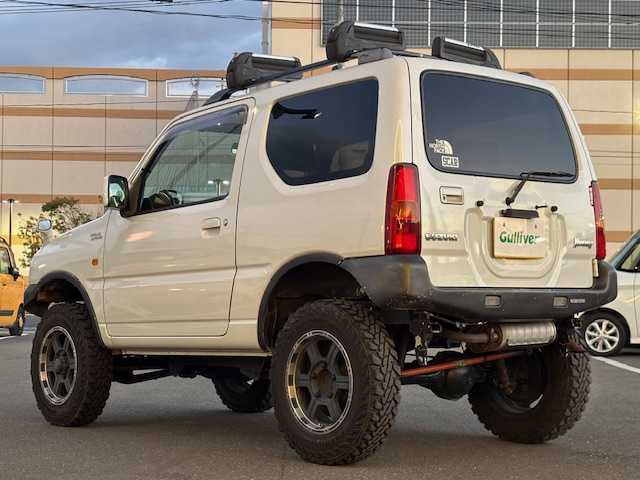 スズキ ジムニー ワイルドウィンド 宮城県 2007(平19)年 15.1万km パールホワイト 登録時走行距離150247km/パワーステアリング/パワーウインド/スペアキー有り/ACエアコン/Bluetooth接続/TV/AM/FM/SD/AUX/HIDヘッドライト/４WD/オフロードマッドタイヤ(ヨコハマ　ジオランダーG003)22年製/ヘッドライトレベライザー/純正フロアマット/純正アルミホイール/ABS/車高調リフトアップ/ルーフレールキャリア付き