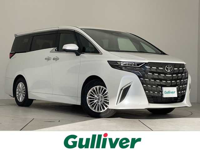 トヨタ アルファードハイブリット X 愛知県 2025(令7)年 0.5万km プラチナホワイトパールマイカ 純正9型ディスプレイオーディオ　ナビ機能なし/フリップダウンモニター/全方位カメラ/三眼LEDヘッドライト/両側パワースライドドア/レーダークルーズコントロール/バックカメラ/コーナーセンサー/純正アルミホイール/ETC2.0/ブラインドスポットモニター/リアオートエアコン/オートマチックハイビーム/衝突軽減システム/フルセグ/Bluetooth/ステアリングスイッチ/スマートキー/プッシュスタート