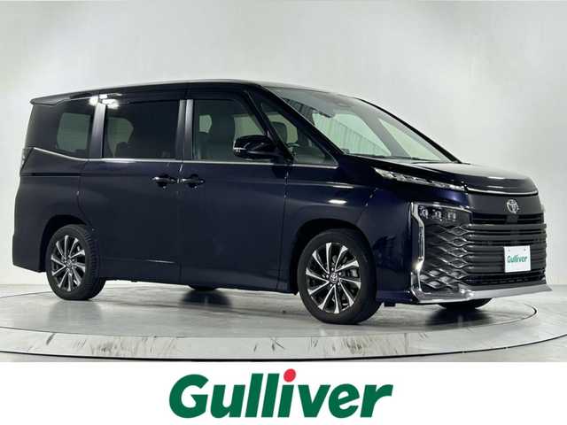 トヨタ ヴォクシー S－Z 佐賀県 2022(令4)年 2万km スパークリングブラックパールクリスタルシャイン ワンオーナー/メーカーOP純正10.5インチディスプレイオーディオ/＜TV/ナビ/DVDキット付き＞/パノラミックビューモニター/純正14インチ有機ELフリップダウンモニター/メーカーOP快適利便パッケージHigh/・ハンズフリーデュアルパワースライドドア/・パワーバックドア/・オットマン/・ステアリングヒーター/・２列目シートヒーター/・ナノイーX/メーカーOPデジタルインナーミラー/メーカーOPユニバーサルステップ/プロジェクター式LEDヘッドライト/ハーフレザーシート/シートヒーター＜運転席/助手席/２列目＞/トヨタチームメイト/アドバンスドパーク/トヨタセーフティセンス/・LDA/・BSM/・PCS/・PDA/・コーナーセンサー/・PKSB/・RCTA/・FCTA/・RCD/・SEA/・HUD/・AdvancedDrive/・LCA/・レーダークルーズコントロール