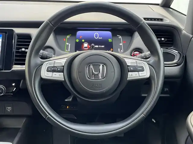 ホンダ フィット e:HEVリュクス 福岡県 2021(令3)年 1.5万km プラチナホワイトパール ホンダセンシング　/社外ナビ　/フルセグＴＶ　/Ｂｌｕｅｔｏｏｔｈ　/オートライト　/ＬＥＤライト／フォグランプ　/前席シートヒーター　/パーキングセンサー　/レザーシート　/革巻きステアリング　/ＡＣＣ　/車線逸脱防止/電動パーキング/ブレーキホールド/ビルドインETC/スマートキー/プッシュスタート/純正アルミホイール/ドアバイザー/ドライブレコーダー