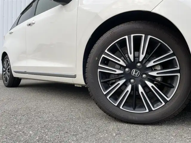 ホンダ フィット e:HEVリュクス 福岡県 2021(令3)年 1.5万km プラチナホワイトパール ホンダセンシング　/社外ナビ　/フルセグＴＶ　/Ｂｌｕｅｔｏｏｔｈ　/オートライト　/ＬＥＤライト／フォグランプ　/前席シートヒーター　/パーキングセンサー　/レザーシート　/革巻きステアリング　/ＡＣＣ　/車線逸脱防止/電動パーキング/ブレーキホールド/ビルドインETC/スマートキー/プッシュスタート/純正アルミホイール/ドアバイザー/ドライブレコーダー