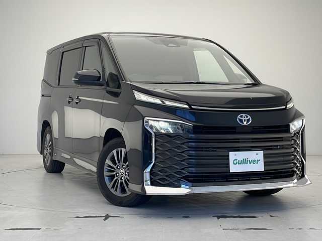 トヨタ ヴォクシー ハイブリッド S－G 沖縄県 2022(令4)年 4.9万km グリッターブラックガラスフレーク 純正10.5インチディスプレイオーディオ　/（フルセグＴＶ　DVD　Ｂｌｕｅｔｏｏｔｈ接続　HDMI）/バックカメラ/ＥＴＣ/両側パワースライドドア/トヨタセーフティセンス/・衝突被害軽減ブレーキ (プリクラッシュセーフティ)																									/・ハンドル操作サポート (レーントレーシングアシスト)																									/・追従ドライブ支援機能 (レーダークルーズコントロール)																									/・車線はみ出しアラート (レーンディパーチャーアラート)																									/・自動ハイビーム (オートマチックハイビーム)																									/ステアリングスイッチ/シートヒーター/クリアランスソナー/ＢＳＭ/ＬＥＤヘッドライト/オートライト/スマートキー/プッシュスタート/保証書/取扱説明書