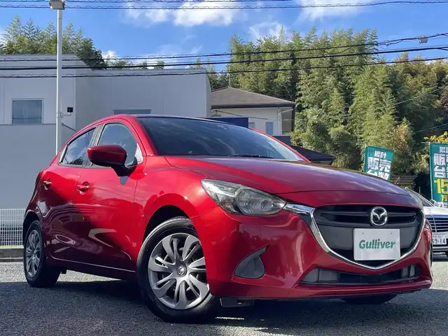 マツダ デミオ 13S 熊本県 2015(平27)年 9.5万km ソウルレッドプレミアムメタリック 純正ナビ/【ワンセグテレビ/Bluetooth/USB/AM/FM】/バックカメラ/ステアリングスイッチ/アイドリングストップ/横滑り防止/MTモード/プッシュスタート/HID/ヘッドライトレベライザー/スマートキー/スペアキー/ドアバイザー/取扱説明書