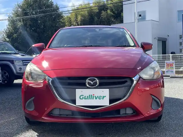 マツダ デミオ 13S 熊本県 2015(平27)年 9.5万km ソウルレッドプレミアムメタリック 純正ナビ/【ワンセグテレビ/Bluetooth/USB/AM/FM】/バックカメラ/ステアリングスイッチ/アイドリングストップ/横滑り防止/MTモード/プッシュスタート/HID/ヘッドライトレベライザー/スマートキー/スペアキー/ドアバイザー/取扱説明書