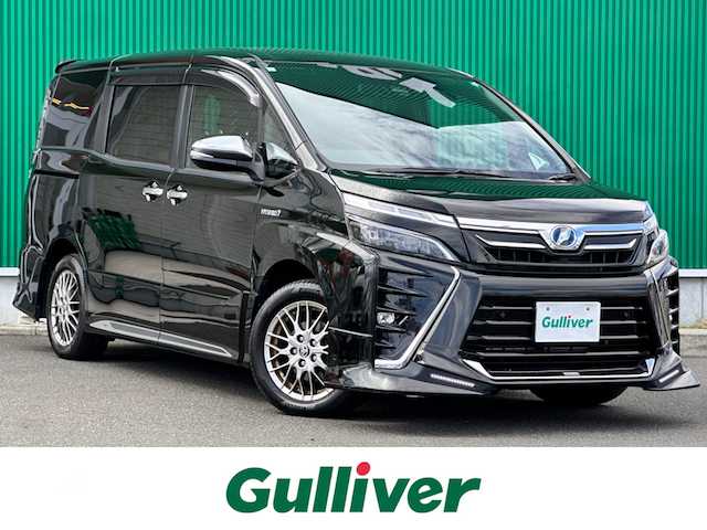 トヨタ ヴォクシー ハイブリッド ZS 煌Ⅱ 宮城県 2019(平31)年 13.6万km イナズマスパーキングブラックガラスフレーク TRDエアロ（F/S/R）/セーフティセンス/・プリクラッシュセーフティ/・レーンディパーチャーアラート/・オートマチックハイビーム/・先行車発進お知らせ機能/インテリジェントクリアランスソナー/パーキングサポートブレーキ/社外10.2インチフリップダウンモニター（TMX-R3300）/社外9インチナビ（AVN-ZX03i）/・CD/DVD/・Bluetooth/・フルセグTV/バックカメラ/ETC/両側パワースライドドア/シートヒーター/革巻きステアリング/クルーズコントロール/ステアリングスイッチ/LEDヘッドランプ/フォグランプ/オートライト/スマートキー＆プッシュスタート/電動格納ミラー/純正16インチAW/純正ドアバイザー/フロアマット/Wエアバッグ