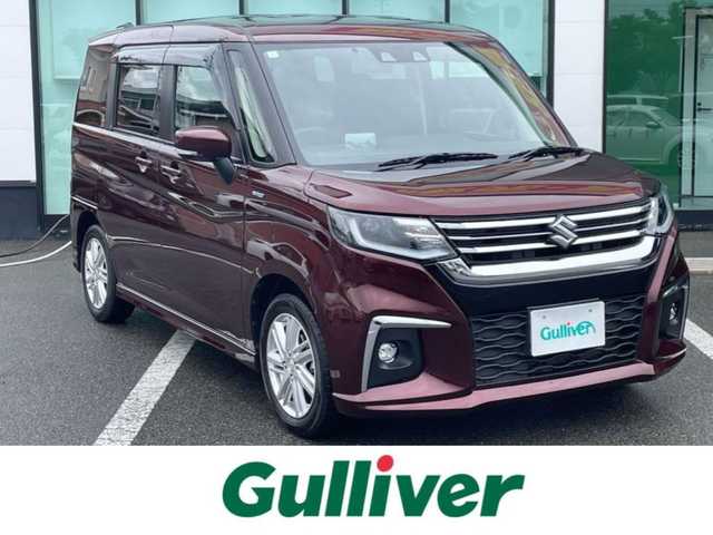 スズキ ソリオ HV MZ 和歌山県 2023(令5)年 1.7万km メロウディープレッドパール 純正8インチナビ/（BT/CD/DVD/USB)/フルセグTV/バックカメラ/衝突被害軽減ブレーキ/横滑り防止/レーンキープアシスト/オートライト/レーダークルーズコントロール/後方コーナーセンサー/ビルトインETC/両側パワスラ/前席シートヒーター/ヘッドアップディスプレイ/ステアリングリモコン/LEDヘッドライト/フォグランプ/純正15インチアルミ/純正フロアマット/プッシュスタート/電格ミラー