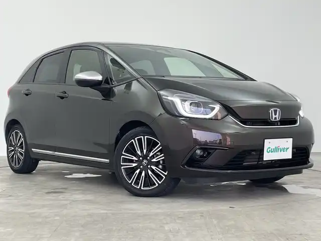 ホンダ フィット e:HEVリュクス 三重県 2021(令3)年 5.4万km プレミアムグラマラスブロンズP 禁煙車/純正9インチナビ/　フルセグTV/CD/DVD/Bluetooth/純正アルミホイール/前席シートヒーター/革巻きステアリング/スマートキー/レーダークルーズコントロール/衝突軽減ブレーキシステムシステム/AAC/ETC/前方ドラレコ/オートライト/プッシュスタート/純正LEDヘッドライト