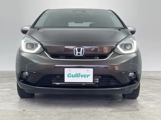 ホンダ フィット e:HEVリュクス 三重県 2021(令3)年 5.4万km プレミアムグラマラスブロンズP 禁煙車/純正9インチナビ/　フルセグTV/CD/DVD/Bluetooth/純正アルミホイール/前席シートヒーター/革巻きステアリング/スマートキー/レーダークルーズコントロール/衝突軽減ブレーキシステムシステム/AAC/ETC/前方ドラレコ/オートライト/プッシュスタート/純正LEDヘッドライト