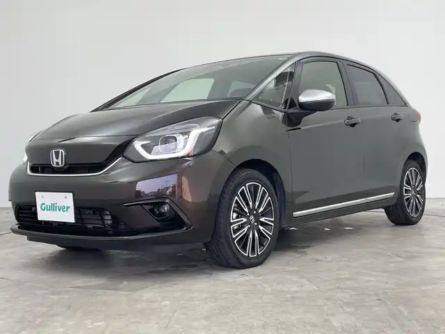 ホンダ フィット e:HEVリュクス 三重県 2021(令3)年 5.4万km プレミアムグラマラスブロンズP 禁煙車/純正9インチナビ/　フルセグTV/CD/DVD/Bluetooth/純正アルミホイール/前席シートヒーター/革巻きステアリング/スマートキー/レーダークルーズコントロール/衝突軽減ブレーキシステムシステム/AAC/ETC/前方ドラレコ/オートライト/プッシュスタート/純正LEDヘッドライト