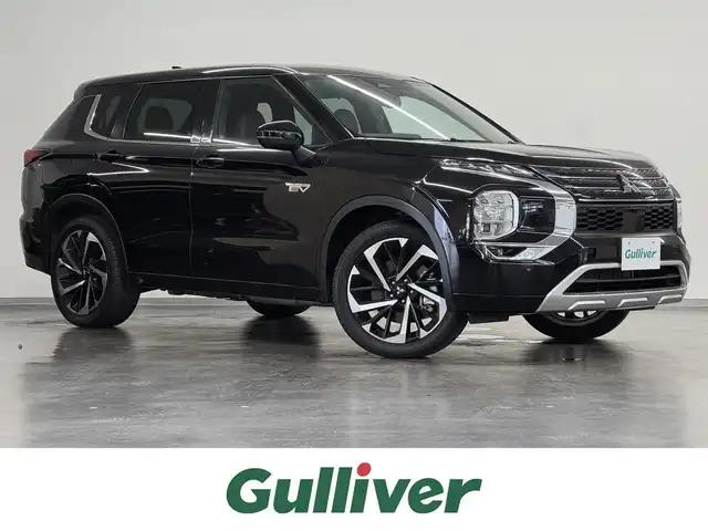 三菱 アウトランダー ＰＨＥＶ P 三重県 2022(令4)年 0.6万km アメジストブラック プラグインハイブリッド/4WD/フロアCVT/9インチナビ/（AM/FM/TV/USB/iPod/Bluetooth/CarPlay/AndroidAuto）/マルチアラウンドモニター（移動物検知機能付）/BOSEプレミアムサウンドシステム（9スピーカー）/ビルトイン ETC2.0/e-Assist/・衝突被害軽減ブレーキ（FCM）/・踏み間違い衝突防止アシスト（EAPM）/・車線逸脱警報（LDW）＆逸脱防止支援（LDP）/・ふらつき警報（DAA）/・前方衝突予測警報（PFCW）/・MI-PILOT（レーダークルコン）/・標識認識システム（TSR）/・後側方衝突被害防止支援システム（ABSA）/・後側方車両検知警報（レーンチェンジアシスト機能付）（BSW/LCA）/・後退時車両検知警報（RCTA）/●パーキングセンサー/●ヒルディセントコントロール/など/装備/・セミアニリン本革シート（ブラック×サドルタン）/・シートヒーター（D/N/2nd左右）/・10wayメモリーパワーシート（D/N）/・HUD/・パワーバックドア/・左右＆後席独立オートエアコン/・100V AC電源（1500W）/・V2H用 DC電源（10kW）/・アダプティブLEDヘッドライト（ALH）/・ワイヤレス充電器/・20AW/など