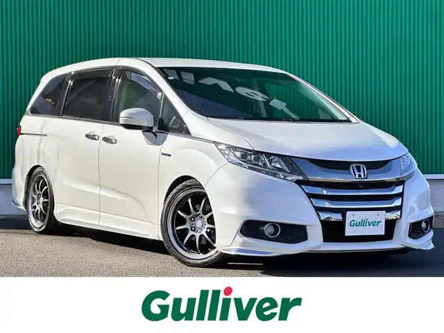 ホンダ オデッセイ ハイブリッド アブソルートセンシングEXパック 宮城県 2016(平28)年 13.1万km ホワイトオーキッドパール Hondaインターナビ＋リンクアップフリー＋ETC車載器（ナビ連動）/マルチビューカメラシステム＋スマートパーキングアシストシステ/＝＝＝/ホンダセンシング/●衝突軽減ブレーキ 〈CMBS〉/●歩行者事故低減ステアリング/●ACC 〈アダプティブ・クルーズ・コントロール〉/●LKAS 〈車線維持支援システム〉/●路外逸脱抑制機能/●誤発進抑制機能/●先行車発進お知らせ機能/●標識認識機能/ブラインドスポットインフォメーション/純正フリップダウンモニター/Hondaインターナビ/【CD/DVD/HDMI/SD/USB/IPOD】/AC100V/1500W/両側パワースライドドア/ハーフレザーシート/運転席パワーシート/WORK18インチアルミホイール/TEIN車高調/TEIN EDFC ACTIVE PRO/LEDヘッドライト/LEDフォグランプ/サンシェード/ステアリングスイッチ/ドアバイザー/純正フロアマット/保証書/取扱説明書/スペアキー/TVキット/純正サスペンション積込