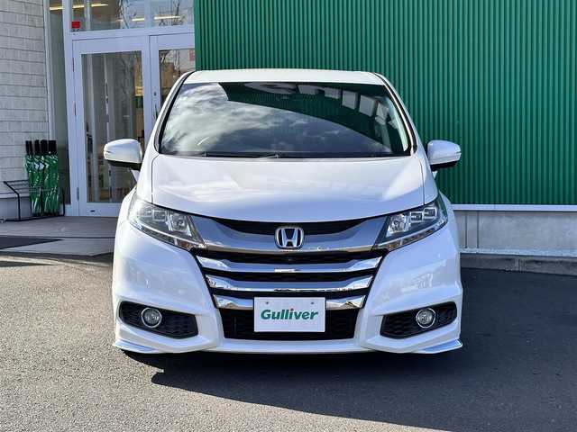 ホンダ オデッセイ ハイブリッド アブソルートセンシングEXパック 宮城県 2016(平28)年 13.1万km ホワイトオーキッドパール Hondaインターナビ＋リンクアップフリー＋ETC車載器（ナビ連動）/マルチビューカメラシステム＋スマートパーキングアシストシステ/＝＝＝/ホンダセンシング/●衝突軽減ブレーキ 〈CMBS〉/●歩行者事故低減ステアリング/●ACC 〈アダプティブ・クルーズ・コントロール〉/●LKAS 〈車線維持支援システム〉/●路外逸脱抑制機能/●誤発進抑制機能/●先行車発進お知らせ機能/●標識認識機能/ブラインドスポットインフォメーション/純正フリップダウンモニター/Hondaインターナビ/【CD/DVD/HDMI/SD/USB/IPOD】/AC100V/1500W/両側パワースライドドア/ハーフレザーシート/運転席パワーシート/WORK18インチアルミホイール/TEIN車高調/TEIN EDFC ACTIVE PRO/LEDヘッドライト/LEDフォグランプ/サンシェード/ステアリングスイッチ/ドアバイザー/純正フロアマット/保証書/取扱説明書/スペアキー/TVキット/純正サスペンション積込