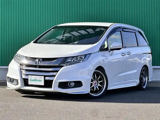 ホンダ オデッセイ ハイブリッド アブソルートセンシングEXパック 宮城県 2016(平28)年 13.1万km ホワイトオーキッドパール Hondaインターナビ＋リンクアップフリー＋ETC車載器（ナビ連動）/マルチビューカメラシステム＋スマートパーキングアシストシステ/＝＝＝/ホンダセンシング/●衝突軽減ブレーキ 〈CMBS〉/●歩行者事故低減ステアリング/●ACC 〈アダプティブ・クルーズ・コントロール〉/●LKAS 〈車線維持支援システム〉/●路外逸脱抑制機能/●誤発進抑制機能/●先行車発進お知らせ機能/●標識認識機能/ブラインドスポットインフォメーション/純正フリップダウンモニター/Hondaインターナビ/【CD/DVD/HDMI/SD/USB/IPOD】/AC100V/1500W/両側パワースライドドア/ハーフレザーシート/運転席パワーシート/WORK18インチアルミホイール/TEIN車高調/TEIN EDFC ACTIVE PRO/LEDヘッドライト/LEDフォグランプ/サンシェード/ステアリングスイッチ/ドアバイザー/純正フロアマット/保証書/取扱説明書/スペアキー/TVキット/純正サスペンション積込