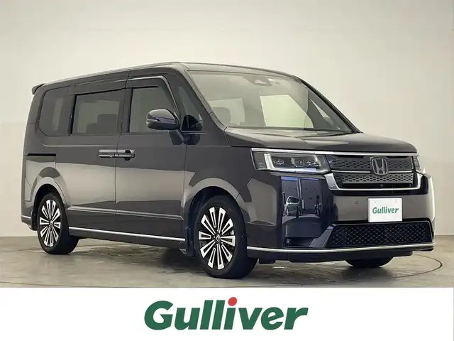 ホンダ ステップワゴン スパーダ eHEV プレミアムライン 滋賀県 2022(令4)年 4.4万km トワイライトミストブラックパール 純正11.4型ナビ/（CD/DVD/SD/Bluetooth/USB/HDMI/フルセグTV）/マルチビューモニター/純正15.6型フリップダウンモニター/前後ドライブレコーダー/ビルトインETC/両側電動スライドドア/パワーバックドア/電動パーキングブレーキ/オートホールドブレーキ/路外逸脱抑制機能/ブラインドスポットインフォメーション/踏み間違い衝突軽減システム/パーキングセンサー警報/衝突軽減ブレーキ/レーンキープアシストシステム/標識認識機能/革巻きステアリング/アダプティブクルーズコントロール/ステアリングリモコン/パドルシフト/ハーフレザーシート/シートヒーター/LEDヘッドライト/フォグランプ/オートヘッドライト/純正アルミホイール/純正フロアマット/USB充電/オートリトラーミラー/カーテンエアバッグ/リアロールサンシェイド