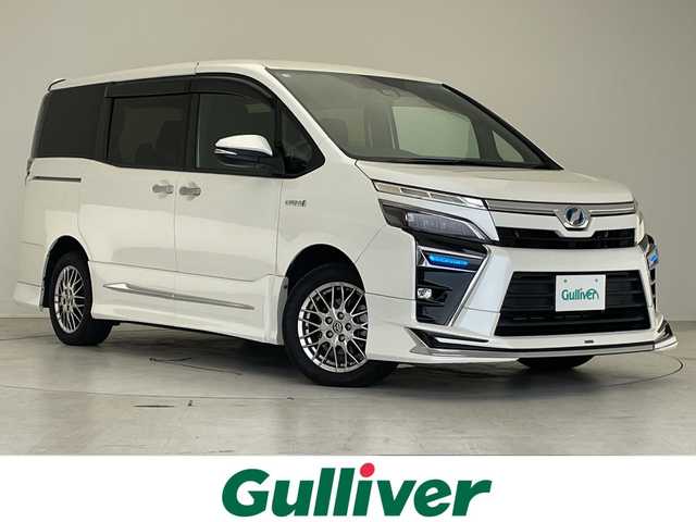 トヨタ ヴォクシー ハイブリッド ZS 煌 愛知県 2018(平30)年 5.1万km ホワイトパールクリスタルシャイン モデリスタエアロ/純正10型ナビ/フリップダウンモニター/両側パワースライドドア/クルーズコントロール/シートヒーター/バックカメラ/純正アルミホイール/LEDヘッドライト/リアオートエアコン/オートマチックハイビーム/ETC/衝突軽減システム/フルセグ/CD DVD/Bluetooth/ステアリングスイッチ/スマートキー/プッシュスタート