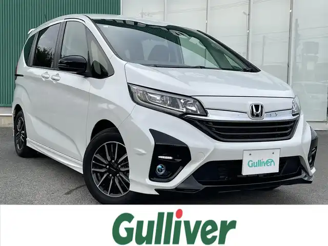 ホンダ フリード ハイブリット モデューロX 福岡県 2023(令5)年 1.4万km プラチナホワイトパール 社外ナビ（BT/フルセグ/DISC/AM/FM)/Bカメラ/両側パワースライドドア/レーダークルーズコントロール/LEDヘッドライト/オートライト/ハーフレザー/ウォークスルー/純正15インチAW/アイドリングストップ/横滑り防止装置/コーナーセンサー/レーンキープアシスト/盗難防止装置/衝突被害軽減システム/スマートキー/ETC