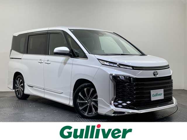 トヨタ ヴォクシー S－Z 愛媛県 2024(令6)年 0.6万km ホワイトパールクリスタルシャイン 純正１０．５型コネクティッドナビ　モデリスタフルエアロ　１３．２型フリップダウンモニター　デジタルインナーミラー　電動リアゲート　ビルトインＥＴＣ２．０　ハーフレザーシート　シートヒーター　禁煙車/・快適利便パッケージ/ハンズフリーパワースライド/ステアリングヒーター/ナノイー/セカンドシートシートヒーター/オットマン/パワーバックドア