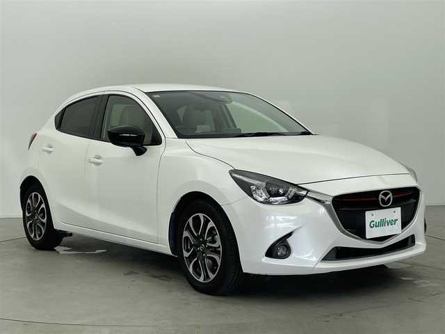 マツダ デミオ XD ツーリング Lパッケージ 富山県 2015(平27)年 5.2万km スノーフレイクホワイトパールマイカ 純正ナビ（AM/FM/BT/USB）/ヘッドアップディスプレイ/クルーズコントロール/衝突被害軽減システム/横滑り防止装置/アイドリングストップ/ハーフレザーシート/オートLEDライト/フォグライト/純正アルミホイール/フロアマット/革巻きステアリング/ステアリングスイッチ/パドルシフト/スマートキー/スペアキー