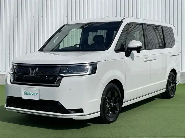 ホンダ ステップワゴン スパーダ eHEV 香川県 2025(令7)年 0.1千km プラチナホワイトパール 純正11.4インチメモリーナビ/→AM/FM/CD/DVD/Bluetooth/フルセグTV/バックカメラ/レーダークルーズコントロール/レーンキープアシスト/両側パワースライドドア/パワーバックドア/シートヒーター/LEDヘッドライト/ホンダセンシング/オットマン/コーナーセンサー/プッシュスタート/スマートキー/スペアキー×1/ステアリングスイッチ/サンシェード/革巻きステアリング/横滑り防止装置