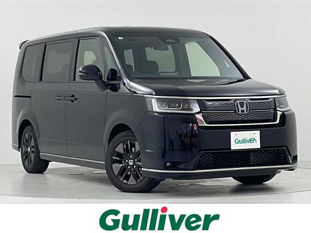 ホンダ ステップワゴン スパーダ eHEV 大阪府 2025(令7)年 0.1千km クリスタルブラックパール ホンダセンシング/　・クリアランスソナー/　・ブラインドスポットフォーメンション/　・急アクセル抑制機能/　・トラフィックジャムアシスト/　・渋滞追従機能付アダプティブクルーズコントロール/　・車線維持支援システム/　・誤発抑制機能/　・後方誤発進抑制機能/純正11.4インチSDナビ/　Bluetooth/フルセグ/CD/DVD/AM/FE/両側パワースライドドア/パワーバックドア/バックカメラ/LEDオーライト/オートハイライト/前席シートヒーター/パドルシフト/オートブレーキホールド/電子パーキング/スマートキー