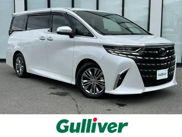 トヨタ アルファード Z 大阪府 2024(令6)年 1.6万km プラチナホワイトパールマイカ トヨタセーフティセンス/純正14インチHDディスプレイオーディオPlus/　（AppleCarplay/AndroidAuto/フルセグTV/Bluetooth/USB）/パノラミックビューモニター/レザーシート（合皮）/　（エグゼクティブパワーシート/シートヒーター/ベンチレーション)/純正14インチフリップダウンモニター/ステアリングヒーター/前後ドライブレコーダー/両側パワースライドドア/パワーバックドア/後席ロールサンシェード/三眼LEDヘッドライト/ビルトインETC2.0/ブラインドスポットミラー/ヘッドアップディスプレイ/ワイヤレス充電/純正18インチアルミホイール/純正フロアマット/TVキャンセラー有