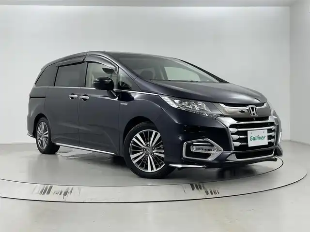 ホンダ オデッセイ ハイブリッド アブソルート・EXホンダセンジング 埼玉県 2018(平30)年 3.1万km プレミアムヴィーナスブラックP 純正9インチナビ　VXM-187VFNi/(Bluetooth/USB/CD/DVD/AM/FM)/地デジフルセグ/バックカメラ/ETC2.0/Honda SENSING/・衝突軽減ブレーキ/・誤発進抑制機能/・路外逸脱抑制機能/・アダプティブ・クルーズ・コントロール/・先行車発進お知らせ機能/・標識認識機能/ブラインドスポットモニター/前席シートヒーター/電子パーキングシステム/ブレーキホールド/プッシュスタート/ステアリングリモコン/両側パワースライドドア/ロールサンシェード/純正フロアマット/純正ドアバイザー/純正17インチアルミホイール
