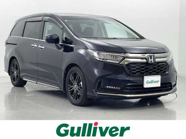 ホンダ オデッセイ ハイブリッド e:HEVアブソルート EX 熊本県 2021(令3)年 6.3万km プレミアムヴィーナスブラックP 純正OPフロントグリル/純正10インチナビ（ＣＤ・ＤＶＤ・フルセグ・ＢＴ・ＳＤ・ＵＳＢ）/全周囲カメラ　/純正前後ドライブレコーダー　/純正後席モニター　/ビルトインＥＴＣ２．０　/ホンダセンシング/・衝突軽減ブレーキ/・誤発進制御機能/・アダブティブクルーズコントロール/・車線維持支援システム/・先行車発進お知らせ機能/・歩行者事故低減ステアリング/・路外逸脱制御機能/・標識認識システム/・ブラインドスポットモニター/横滑り防止/前後クリアランスソナー　/パワーバックドア　/オットマン/純正フロアマット/純正１８インチAW/オートライト/LEDヘッドライト/フォグランプ/スマートキー/プッシュスタート/スペアキー1本/保証書/取扱説明書