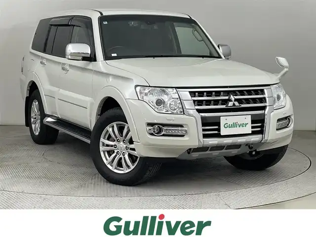 三菱 パジェロ ロング スーパーエクシード 道央・札幌 2019(令1)年 6万km ウォームホワイトパール ・４WD/・寒冷地仕様/・純正SDナビ/・CD／DVD／Bluetooth／フルセグ/・バックカメラ/・ロックフォードサウンド/・ビルトインETC/・前後ドライブレコーダー/・クルーズコントロール/・盗難防止装置/・横滑り防止装置/・トラクションコントロール/・レインセンサー/・本革巻きウッド調ステアリング/・チャイルドシート固定機能付きシートベルト/・レザーシート/・前席シートヒーター/・前席パワーシート/・HIDヘッドライト/・フォグランプ（フロント・リア）/・リモコンキー