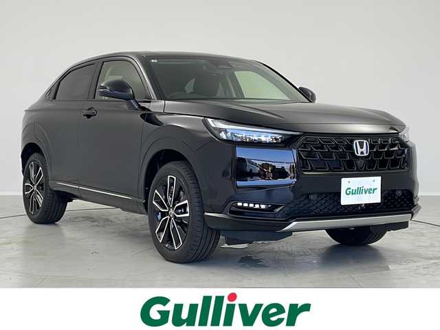 ホンダ ヴェゼル ハイブリッド e:HEV Z 茨城県 2025(令7)年 0.1千km クリスタルブラックパール 登録済未使用車/純正ディスプレイオーディオ/ナビキット有/フルセグ再生可/バックモニター/電動リアゲート/ステアリングヒーター/ワイヤレス充電器/Honda SENSING/・衝突軽減ブレーキ/・誤発進抑制機能/・後方誤発進抑制機能/・路外逸脱抑制機能/・渋滞追従機能付アダプティブクルーズコントロール/・車線維持支援システム/・トラフィックジャムアシスト/・先行車発進お知らせ機能、/・標識認識機能/・オートハイビーム/・パーキングセンサーシステム/・ブラインドスポットモニター/LEDヘッドライト/純正18インチAW/純正ビルトインETC2.0
