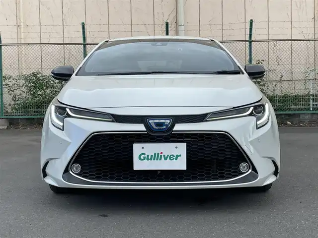 トヨタ カローラツーリング ハイブリッド ダブルバイビー 東京都 2019(令1)年 3.8万km ホワイトパールクリスタルシャイン 9インチディスプレイオーディオ/・バックカメラ/・フルセグテレビ/・Bluetooth/・スマートフォン連携（Apple CarPlay/Android Auto）/・AM/FM/ヘッドアップディスプレイ/トヨタセーフティーセンス/・プリクラッシュセーフティ/・レーントレーシングアシスト/・レーンディパーチャーアラート/・レーダークルーズコントロール（全車速追従機能）/ブラインドスポットモニター/純正フロアマット/ETC/スマートキー/プッシュスタート