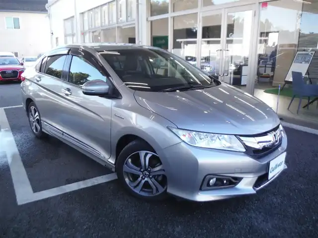 ホンダ グレイス ハイブリッド EX 東京都 2015(平27)年 7.3万km グレー ワンオーナー車/保証書あり/純正ナビ・TV/　BLUETOOTH・HDMI/　バックカメラ・ビルトインETC/ドライブレコーダー/ハーフレザーシート/　前席シートヒーター/あんしんパッケージ/パドルシフト/　クルーズコントロール/モデューロサイドスポイラー/LEDヘッドライト/電動コーナーポール/イルミスカッフプレート/スマートキー×2個